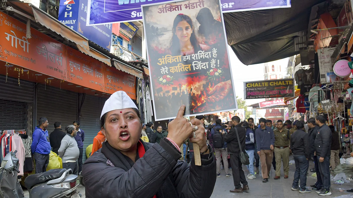 A protester holds a placard during a statewide bandh in Dehradun.