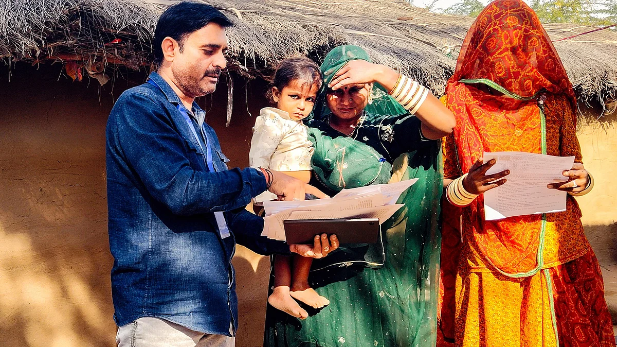 A BLO assists voters with enumeration forms in Bikaner.