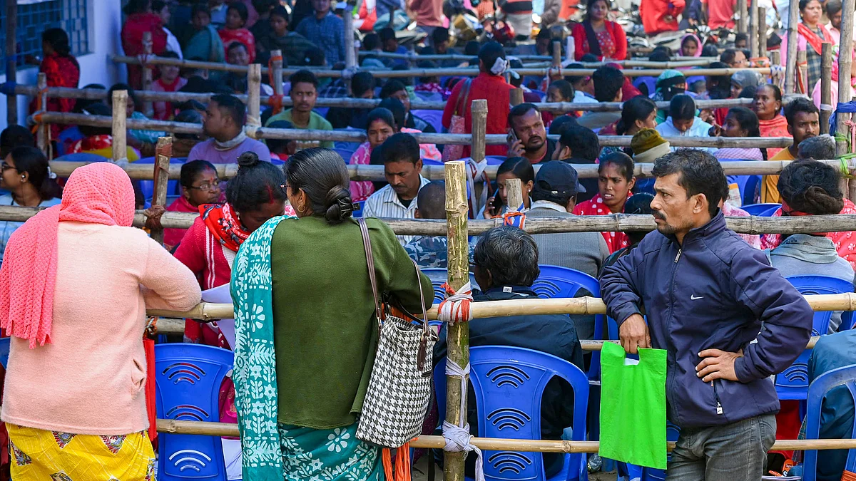 People wait at a centre during SIR hearings in Balurghat, West Bengal.