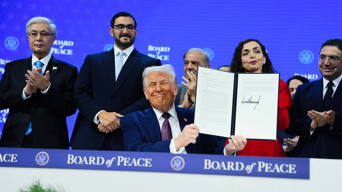 Donald Trump holds up a signed Board of Peace charter at the World Economic Forum in Davos, 22 Jan