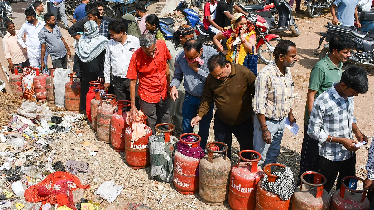 Consumers wait in a queue amidst LPG supply disruptions, in Prayagraj, 23 March