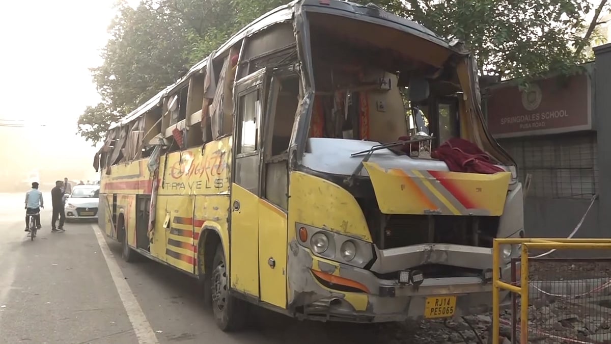 Damaged remains of a sleeper bus after it overturns near Hanuman Mandir in Karol Bagh, New Delhi.