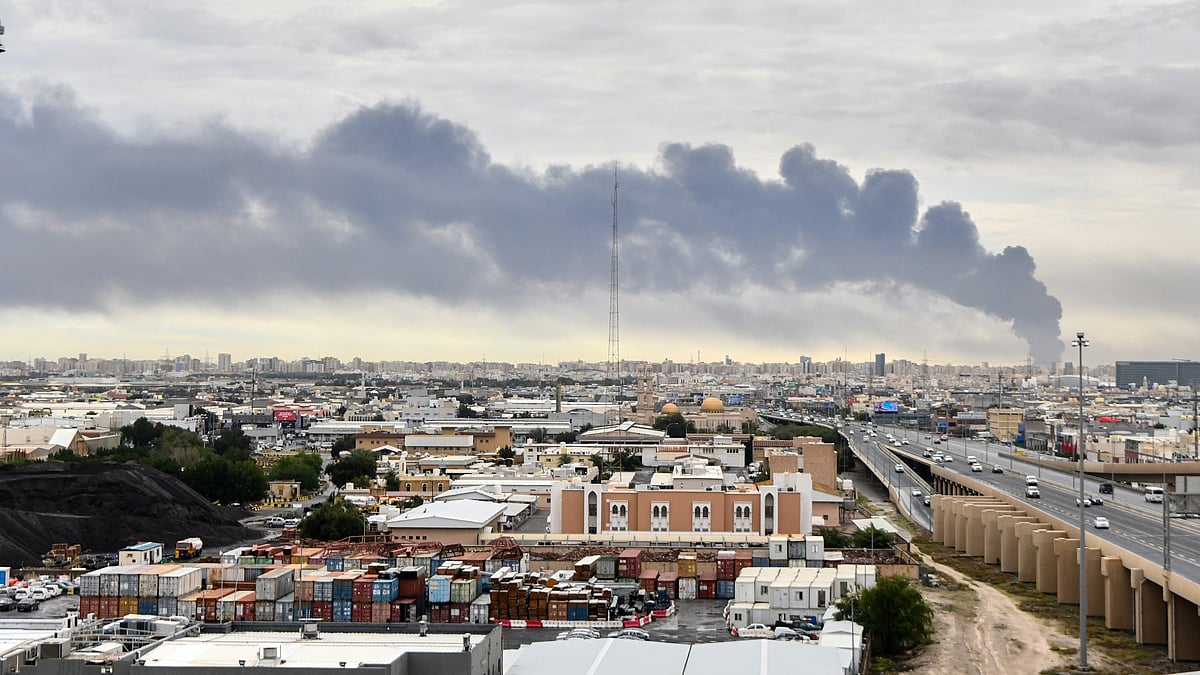 Smoke rises near Kuwait International Airport after a drone strike hit fuel storage.