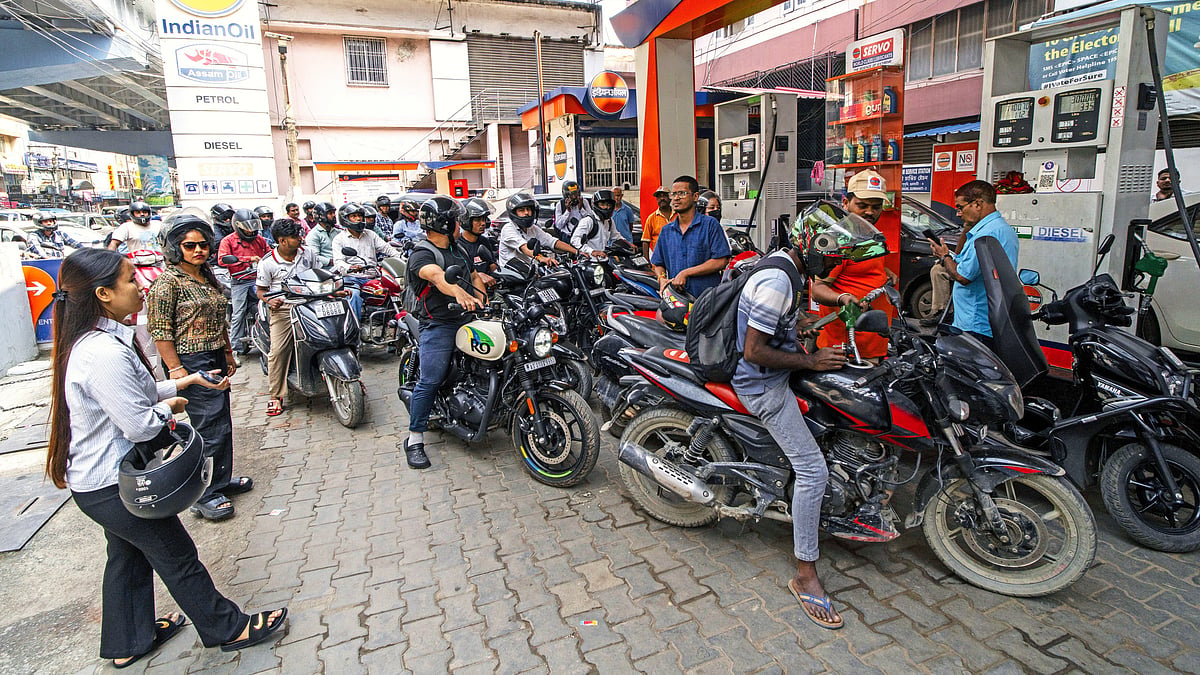 People queue up for fuel refills in Guwahati, Assam, 26 March