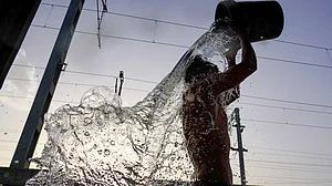 A man cools off with a bath as the heatwave intensifies.