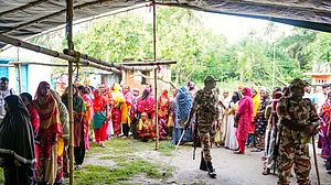 Security personnel stand guard over voters at Magrahat Paschim, South 24 Parganas, 2 May