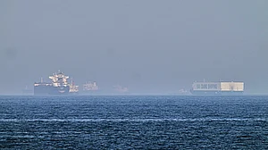 A tanker, left, and a car carrier are anchored at sea in Gulf of Oman near Strait of Hormuz.