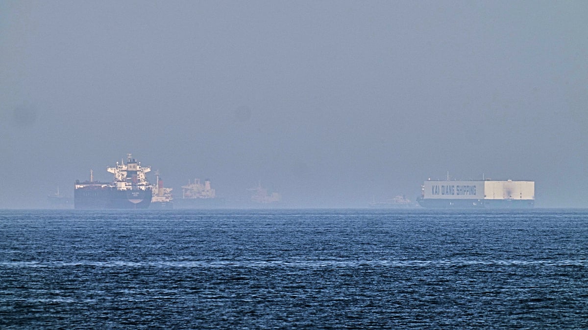A tanker, left, and a car carrier anchored at sea in Gulf of Oman near Strait of Hormuz.