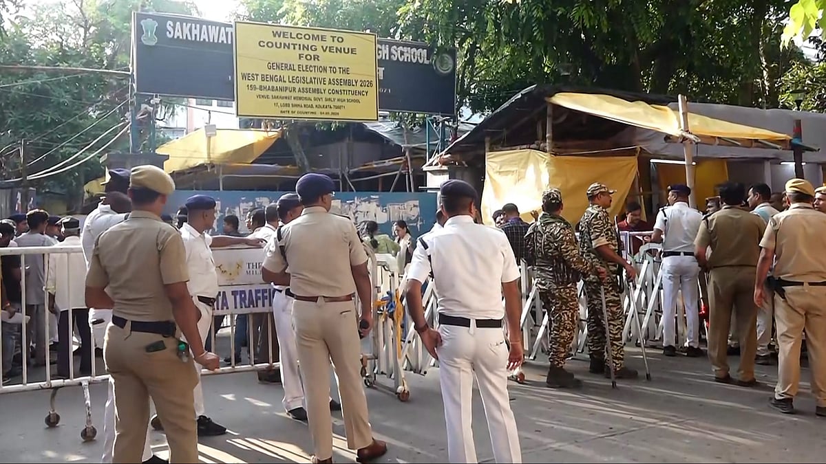 Security personnel and officials outside a vote counting centre in Kolkata.