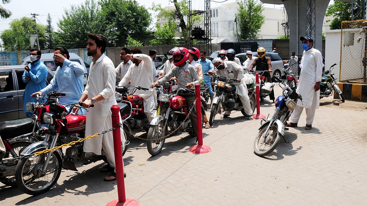 Vehicles wait at a fuel station in northwest Pakistan's Peshawar.