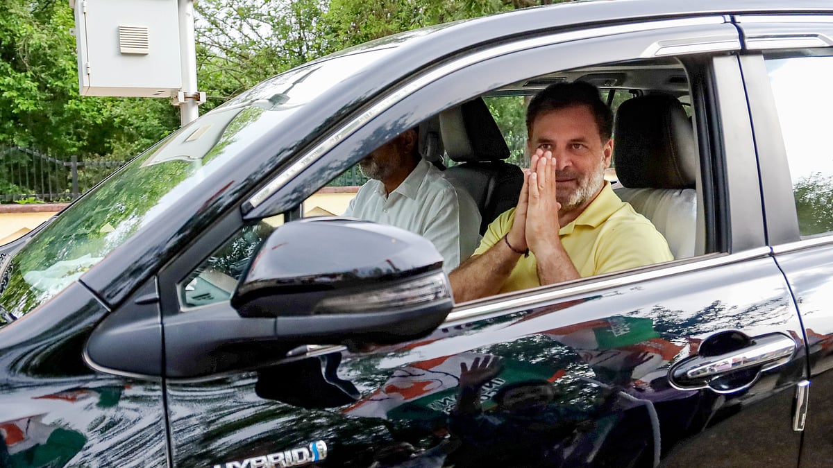 Rahul Gandhi greets as he arrives at Kangra Airport.