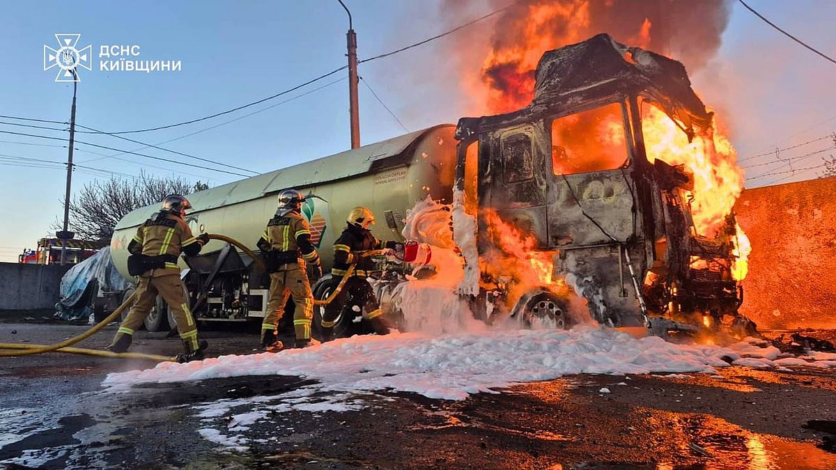 Emergency services personnel extinguish a fire from a Russian drone attack in the Kyiv region, 5 May