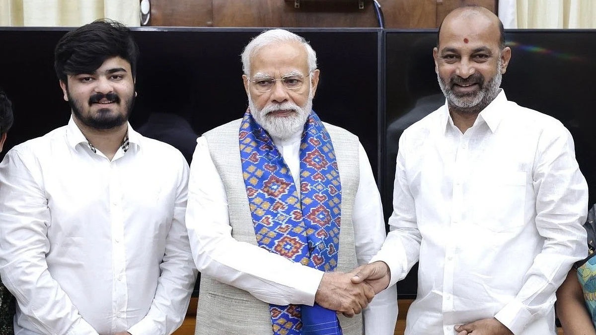 Bandi Sanjay (R) and his son with PM Narendra Modi