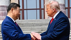 Xi Jinping shakes hands with Donald Trump at the Great Hall of the People in Beijing, 14 May