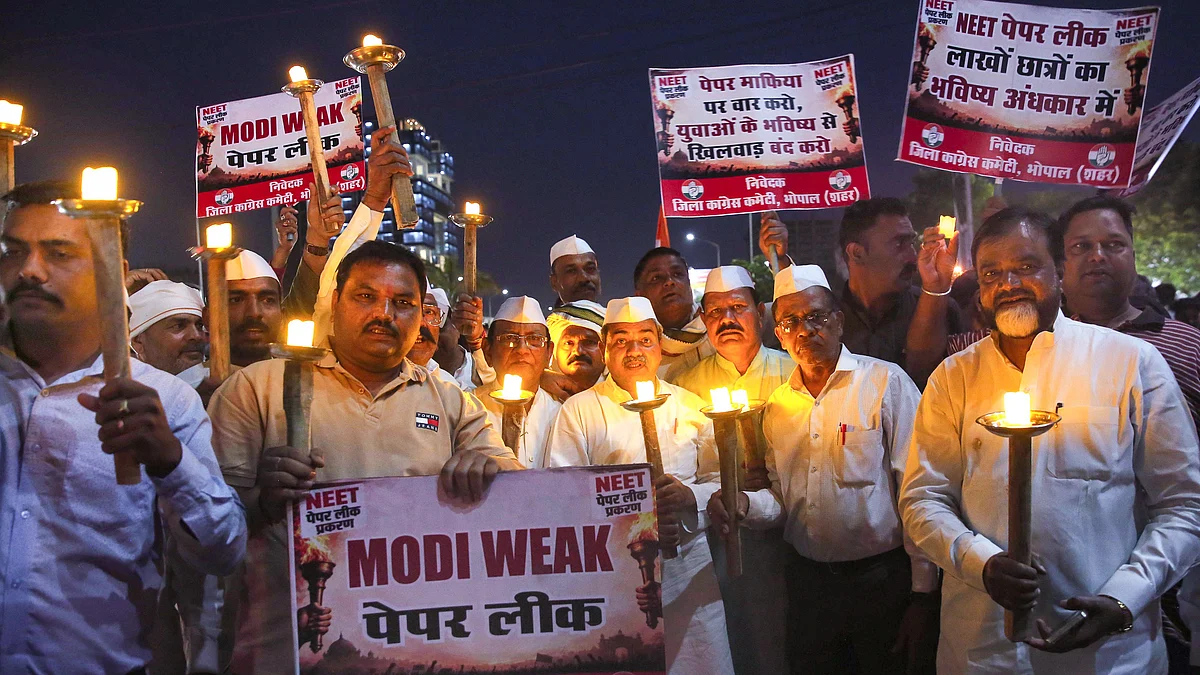 Congress workers take out a torch rally in protest against the cancellation of NEET-UG 2026.