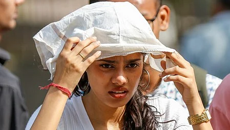 A woman shields herself from the scorching heat in New Delhi.