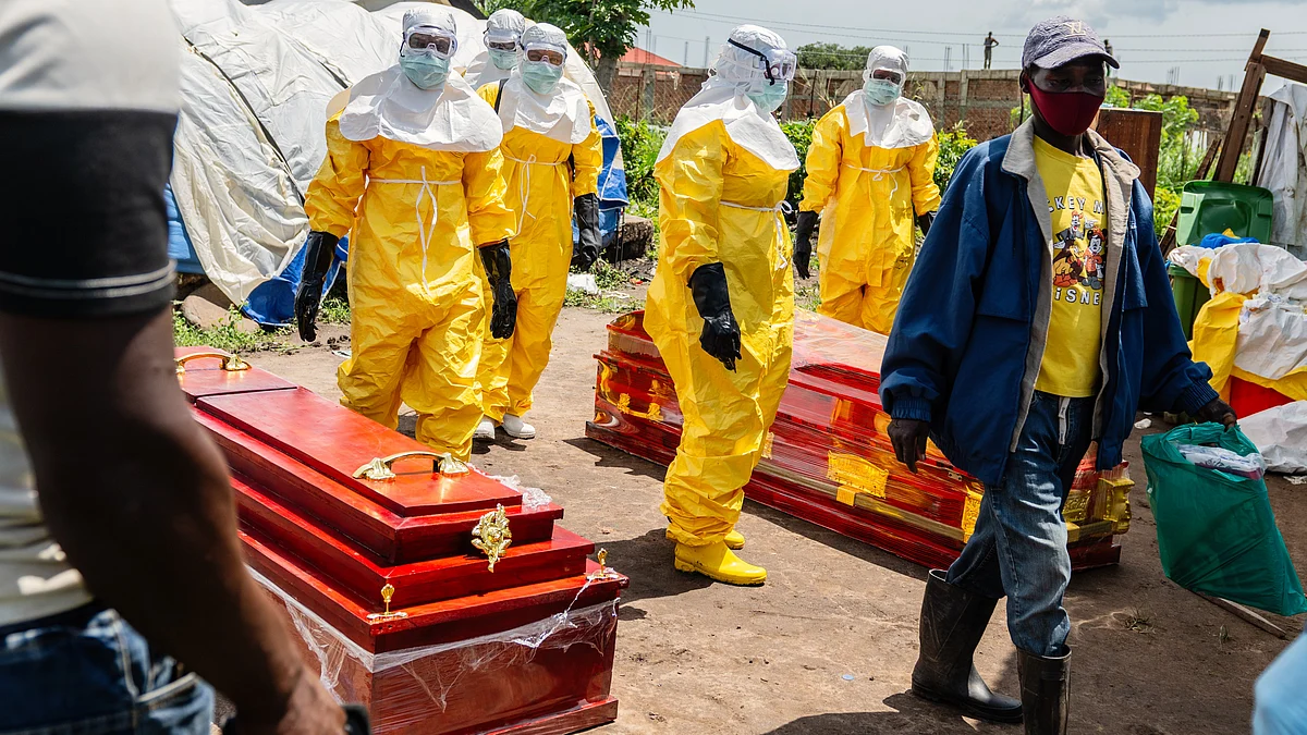 Red Cross workers arrive at a health centre to transport dead Ebola victims in Rwampara, Congo, 20 May