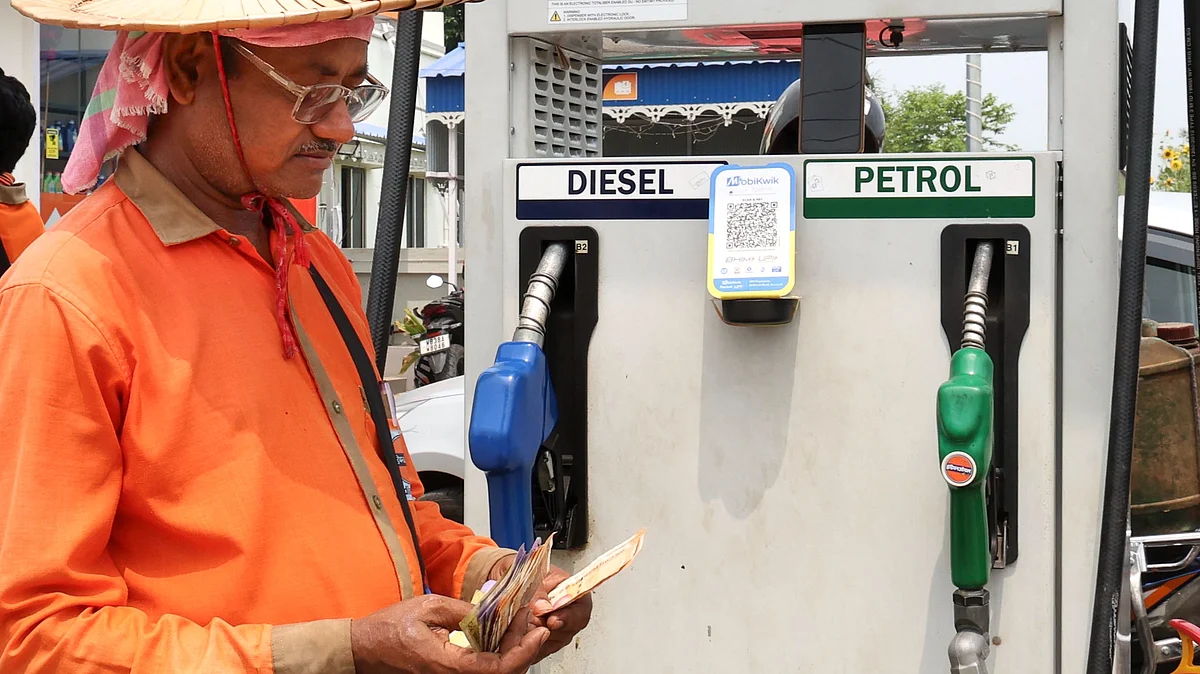 An employee counts money at a fuel station in Birbhum, West Bengal.