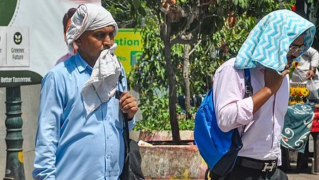 People shield themselves from the scorching heat amid intense heatwave conditions.