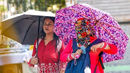 Two young women brave through the Delhi heat