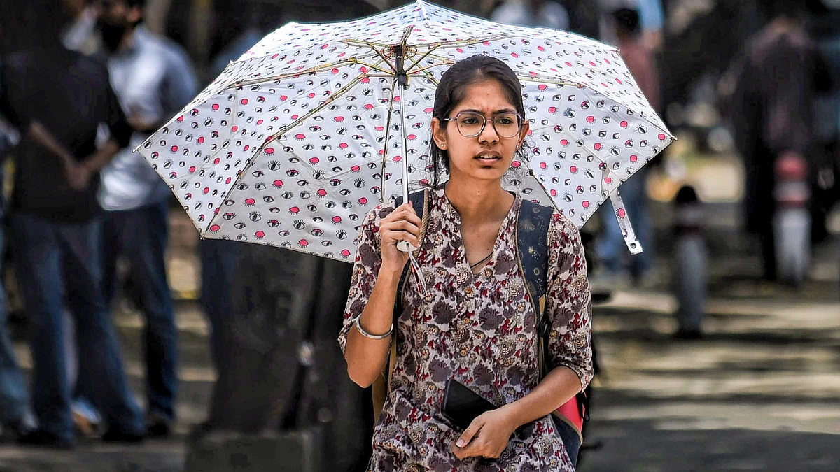 A girl shields herself from the scorching sun in New Delhi.