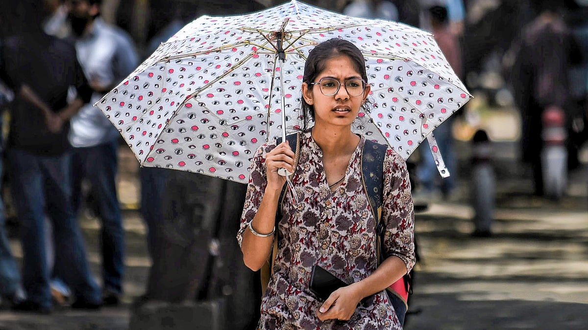 A girl shields herself from the scorching sun in New Delhi.