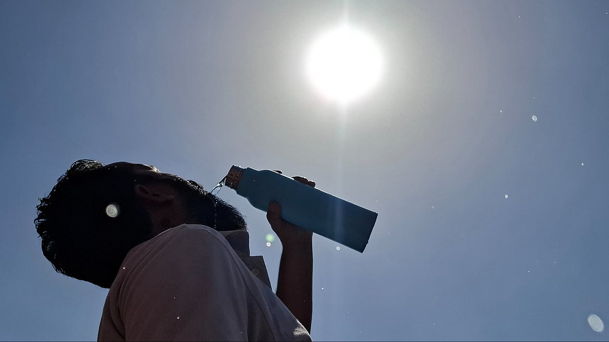A man quenches his thirst amid scorching heatwave conditions in Jammu.