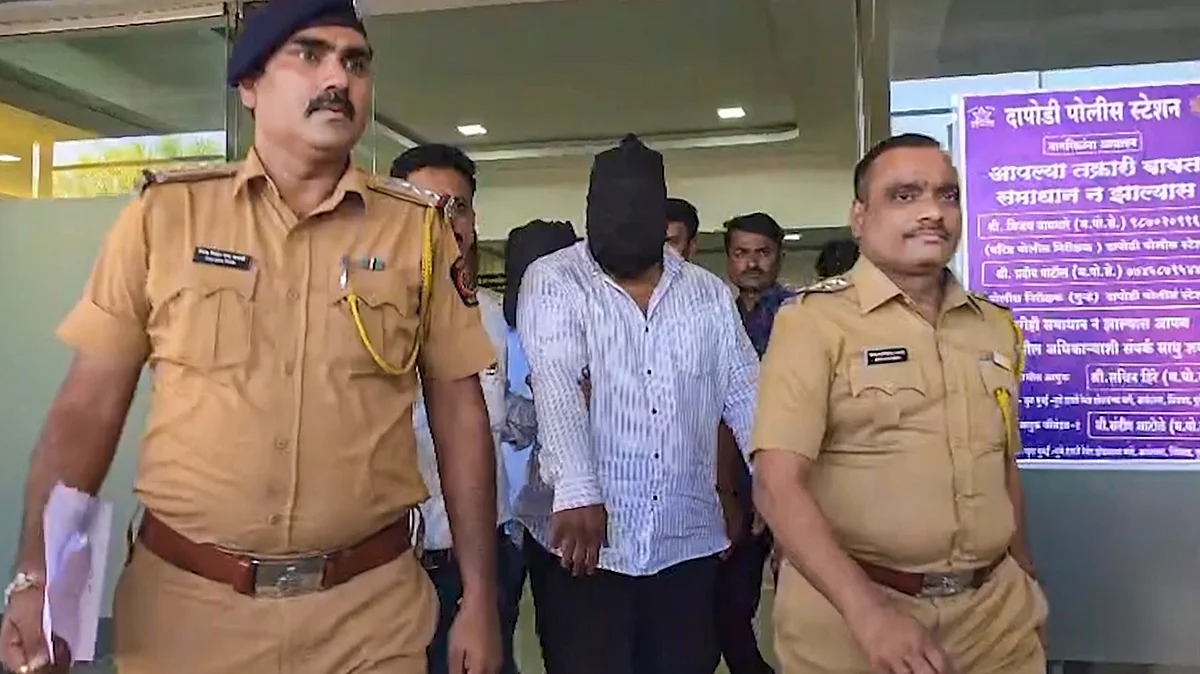 Police escort an accused in connection with the spurious liquor tragedy, in Pune, 29 May