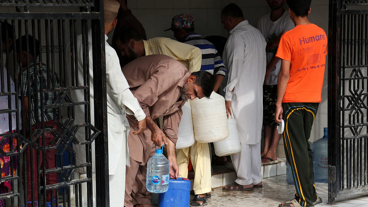 Residents collect water in Karachi.