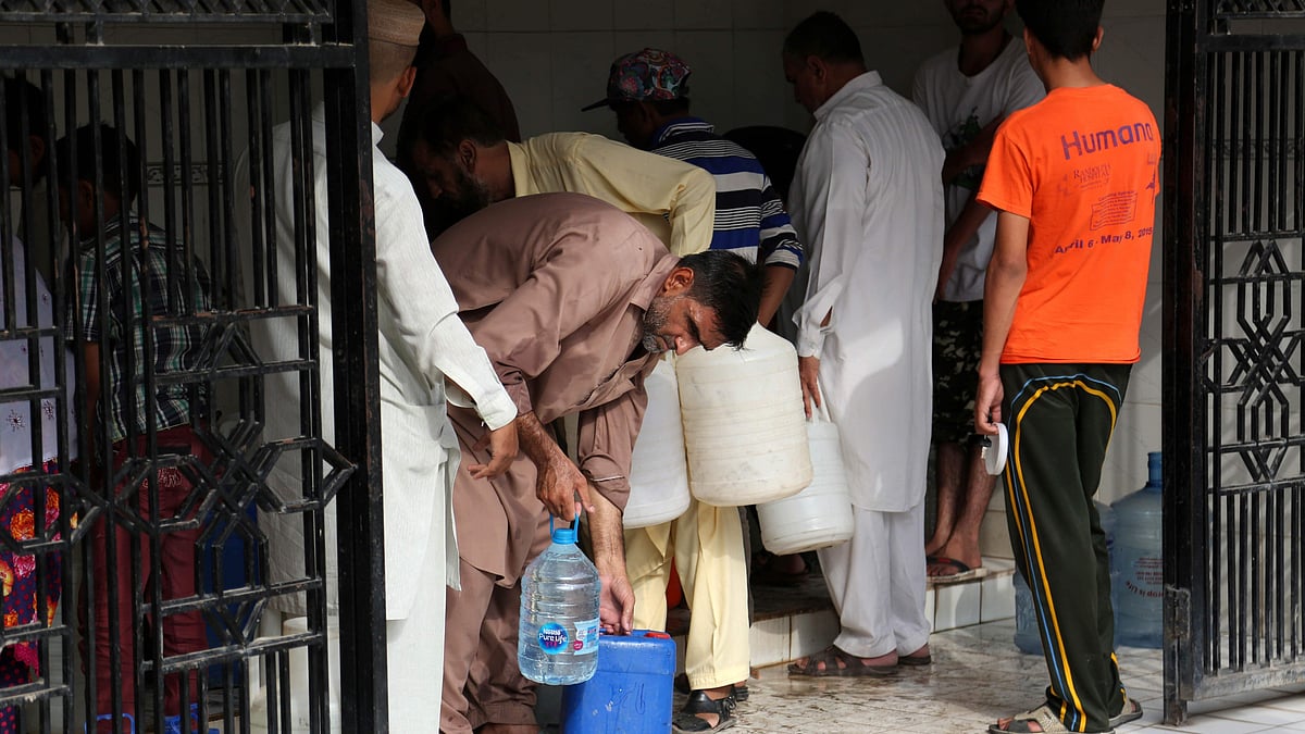Residents collect water in Karachi.