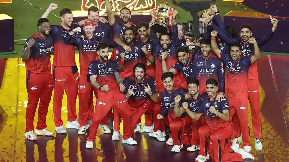 Royal Challengers Bengaluru celebrate with winners' trophy