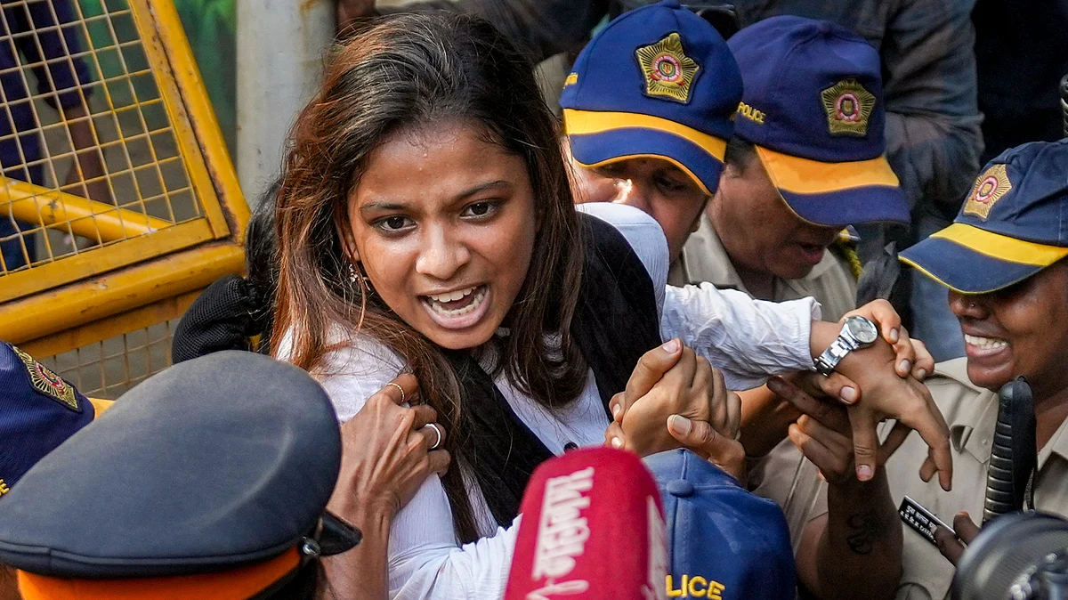 Mumbai: Police personnel detains a Youth Congress worker after a protest march.
