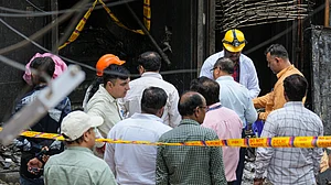 Forensic officials at the site after fire broke out at a b&b in a 5-storey building in Delhi.