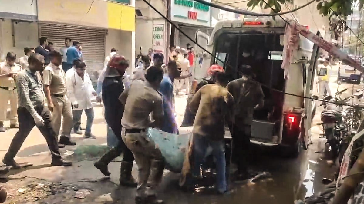 Police, firefighters and health officials at Malviya Nagar restaurant fire site in New Delhi.