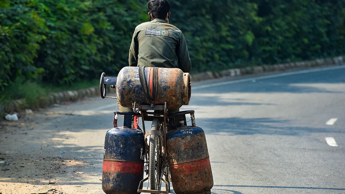 File photo of a man carrying LPG cylinders.