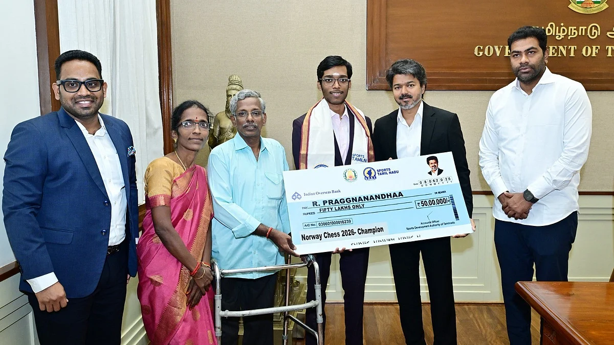 C. Joseph Vijay hands over Rs 50 lakh cheque to Grandmaster R. Praggnanandhaa.