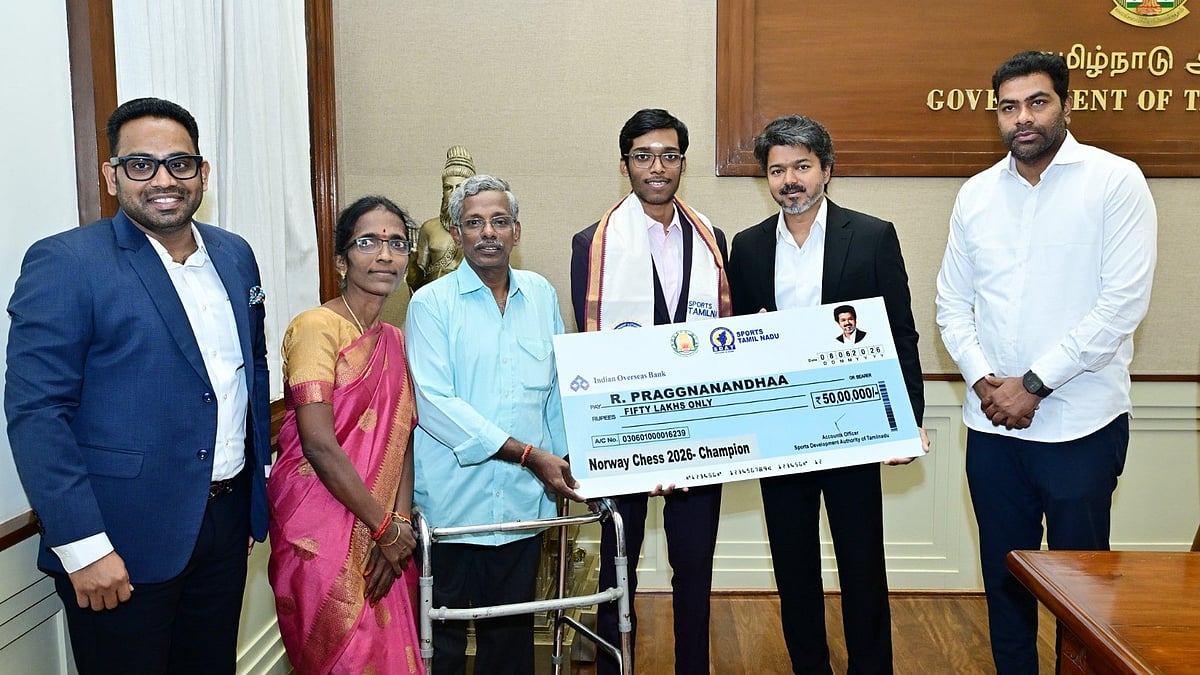 C. Joseph Vijay hands over Rs 50 lakh cheque to Grandmaster R. Praggnanandhaa.  