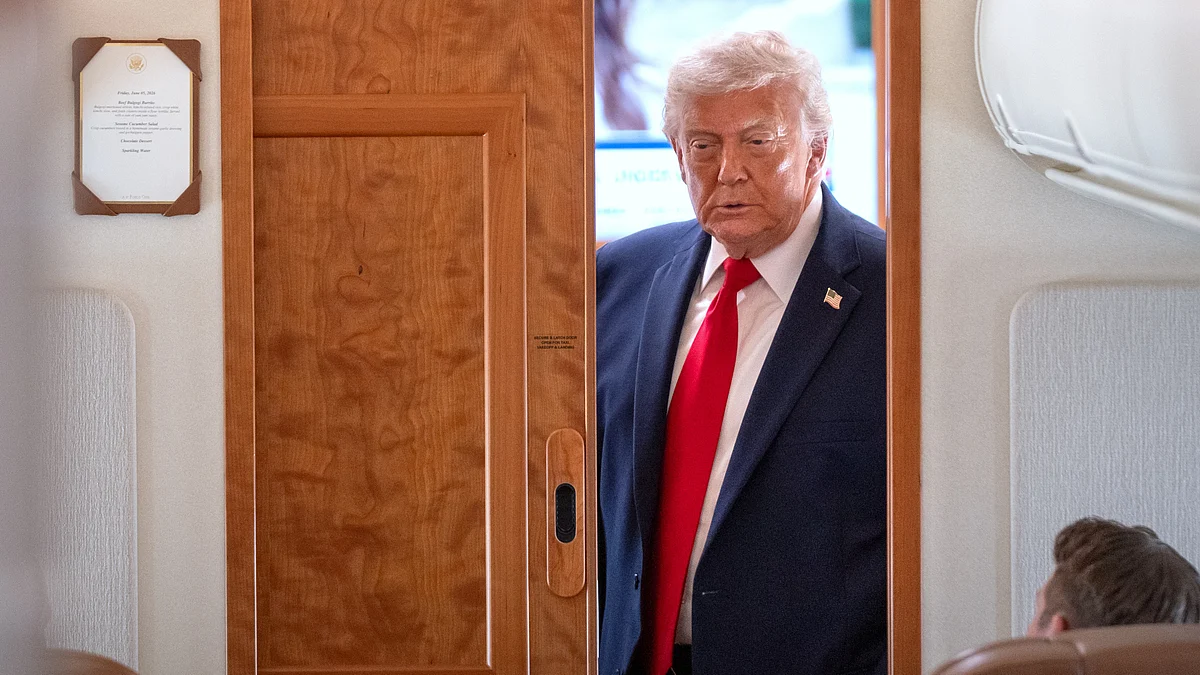 Donald Trump speaks to reporters aboard Air Force One during travel briefing.