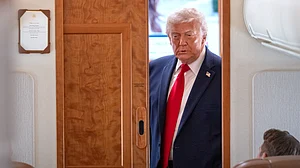 Donald Trump speaks to reporters aboard Air Force One during travel briefing.