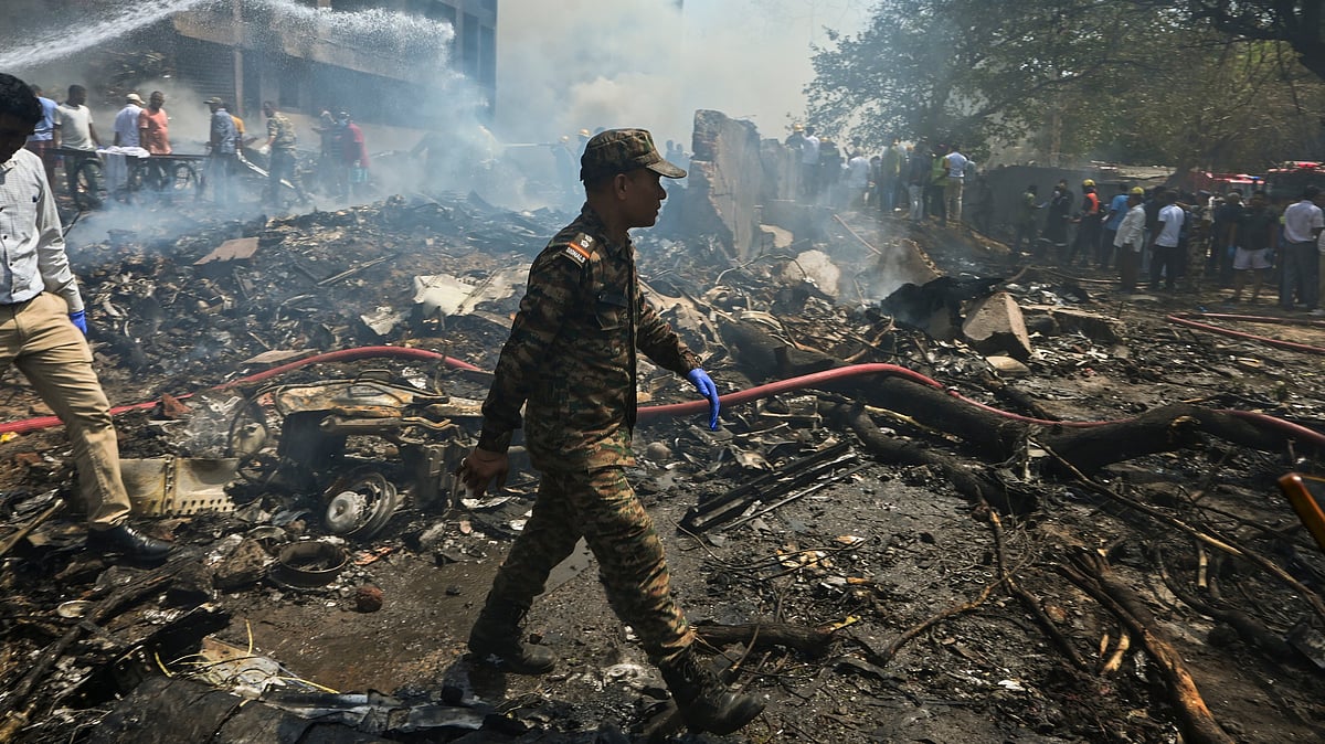 Smoke billows after an AI plane crashes near Ahmedabad airport on 12 June 2025.
