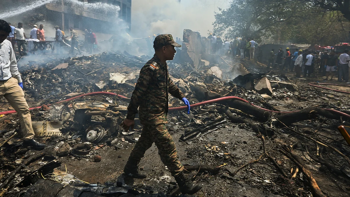 Smoke billows after an AI plane crashes near Ahmedabad airport on 12 June 2025.