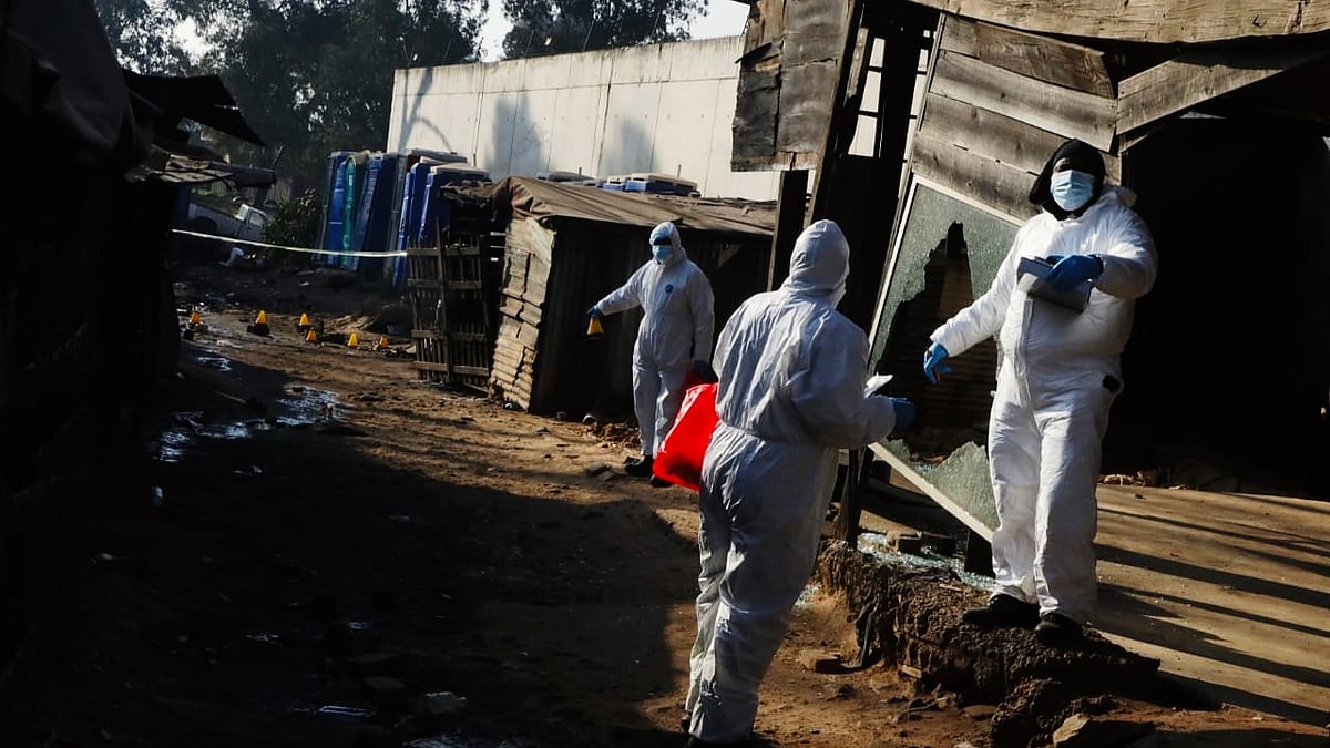 Investigators at the Cleveland informal settlement on 10 June
