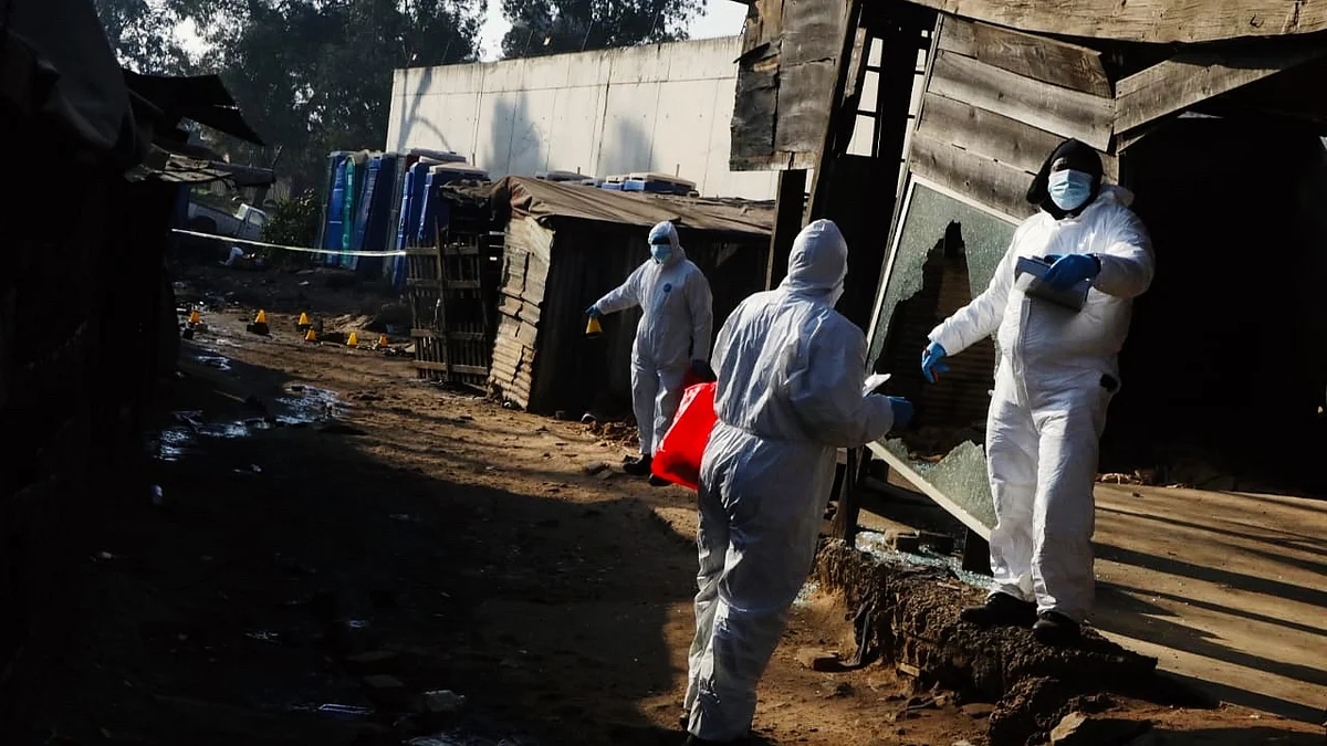 Investigators at the Cleveland informal settlement on 10 June