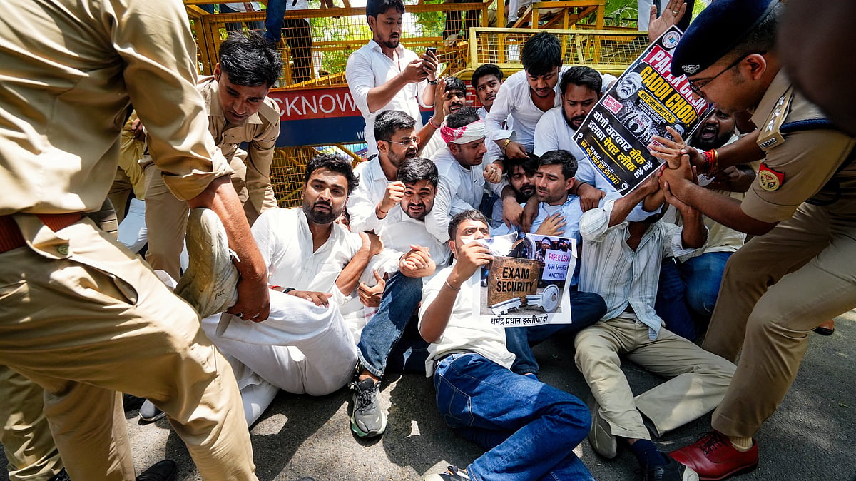 Police detain NSUI members during a protest against the NEET paper leak, in Lucknow, 14 June
