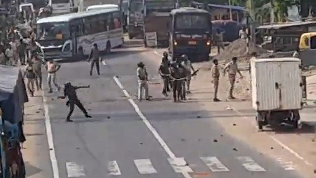 Police in action to disperse protesters during clashes in Nagarnausa, Nalanda.