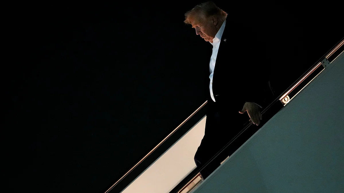 Donald Trump disembarks Air Force One after attending the G7 summit in France, 18 June