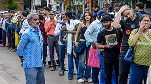 Stranded commuters line up for taxis outside Dadar Station.