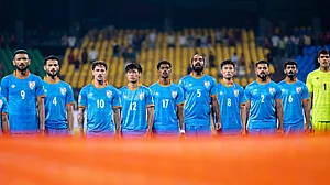 Blue Tigers stand for the national anthem before a recent game