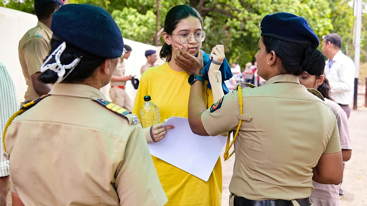 A candidate undergoes a security check at an exam centre in Nagpur, 21 June