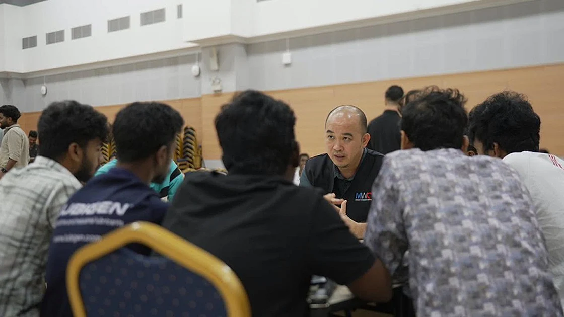 A MWC representative engaging affected migrant workers